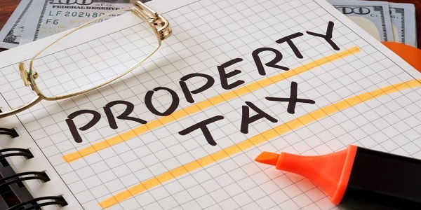 Notebook with property tax sign on a table. Business concep