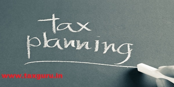 Hand writing Tax Planning word with chalk