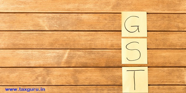 GST Goods and services and Tax inscription on wooden background