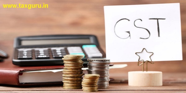 GST  Goods and Services TAx on paper with coins and calculator