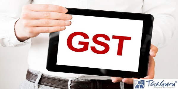 Text GST GOODS AND SERVICES TAX on tablet display in businessman hands on the white bakcground