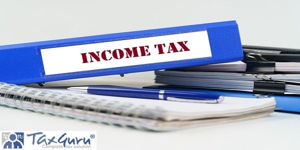 Income Tax - on the table are a notebook, a pen, documents and a folder with the inscription