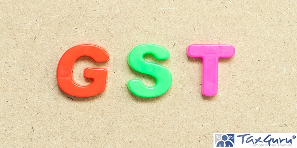 Color alphabet letter with word GST (Abbreviation of Goods and Service Tax) on wood background