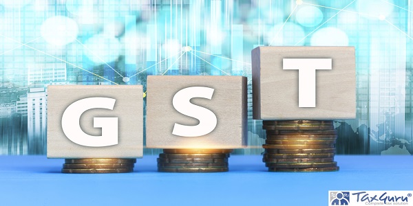 GST Concept with wooden block on a stacked of coins