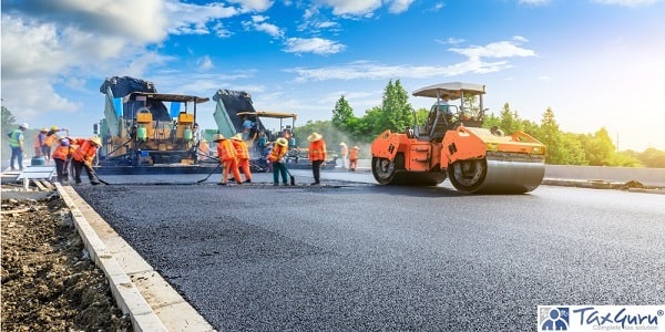Road construction workers and road construction machinery scene